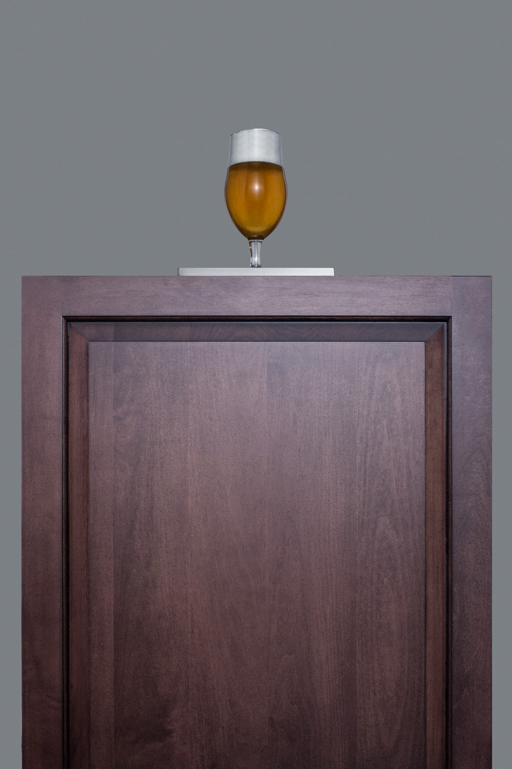 Built-in undercounter ADA height commercially listed beer dispenser with panel-ready door and black cabinet; no tapping equipment included